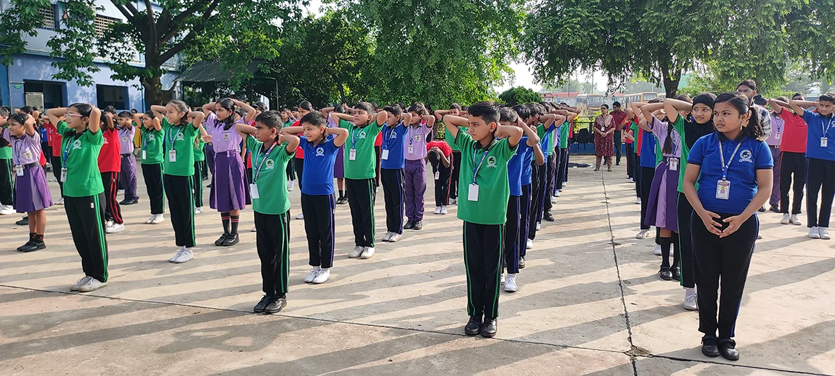 Students standing in rows during a school assembly at Don Bosco Ramkanali