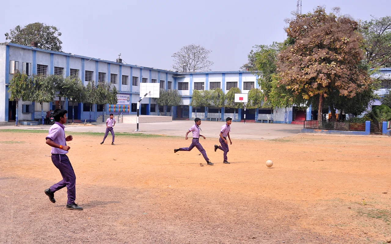 Students playing football on the Don Bosco Ramkanali school ground